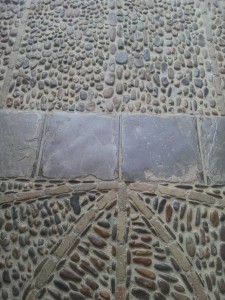 cobblestone fields laid between radial brick lines / stone flags / lines of cobblestones - all laid in concrete