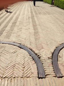 overview of herringbone laid brick Crossing Court showing gate wheel gutters with wooden fillers