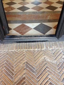 transition from the Crossing Courtyard's yellow brick onto 3-coloured marble tiles. Please not that this door is set in a larger door and that the whole is opened for the robot thus removing this wooden door sill