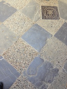 chequer: flagstones/cobbles in concrete with inset drain cover